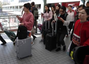 Marching through malls, Hong Kong protesters urge mainland Chinese traders to leave