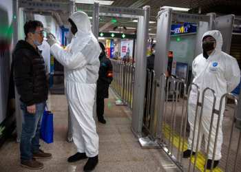 Panic on flight as passenger is taken off by medic in hazmat suit